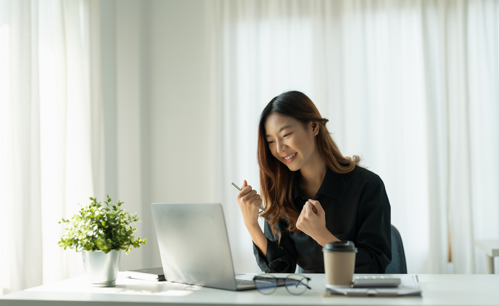 Happy Business Woman at her Desk